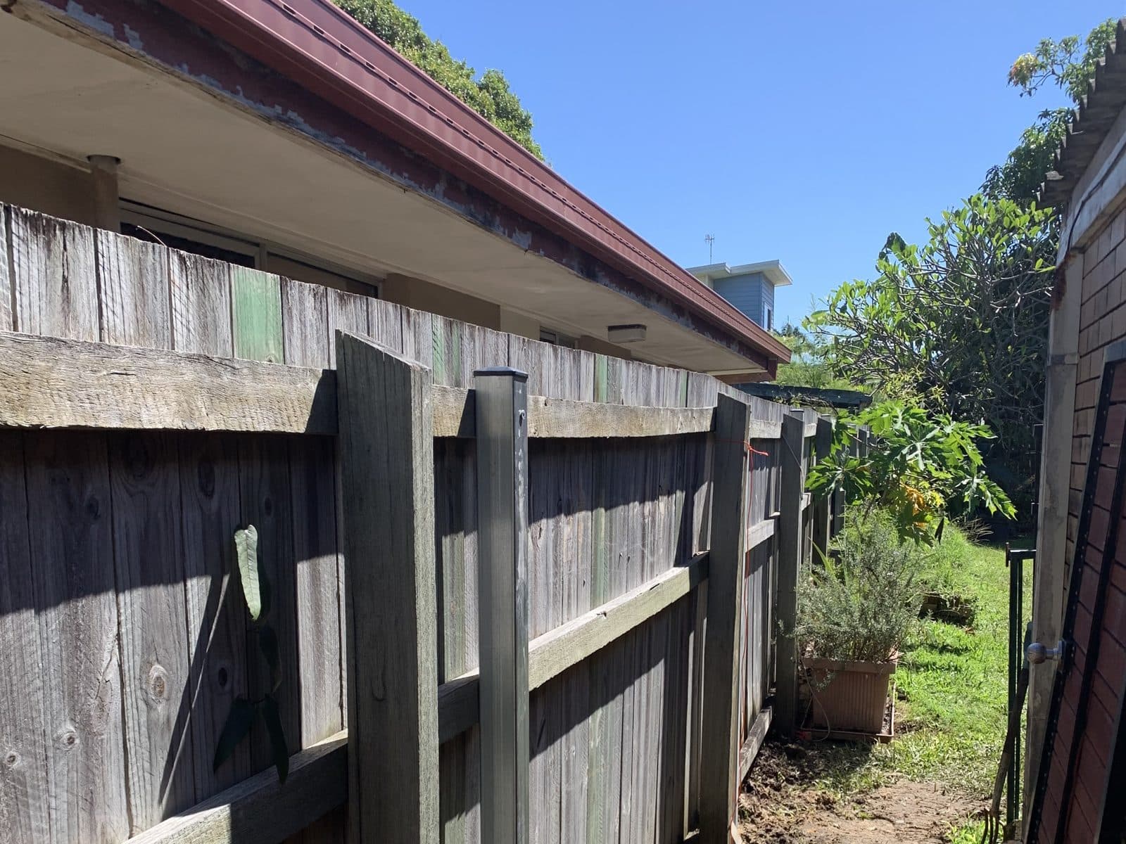 The same fence standing straight on new galvanised steel posts